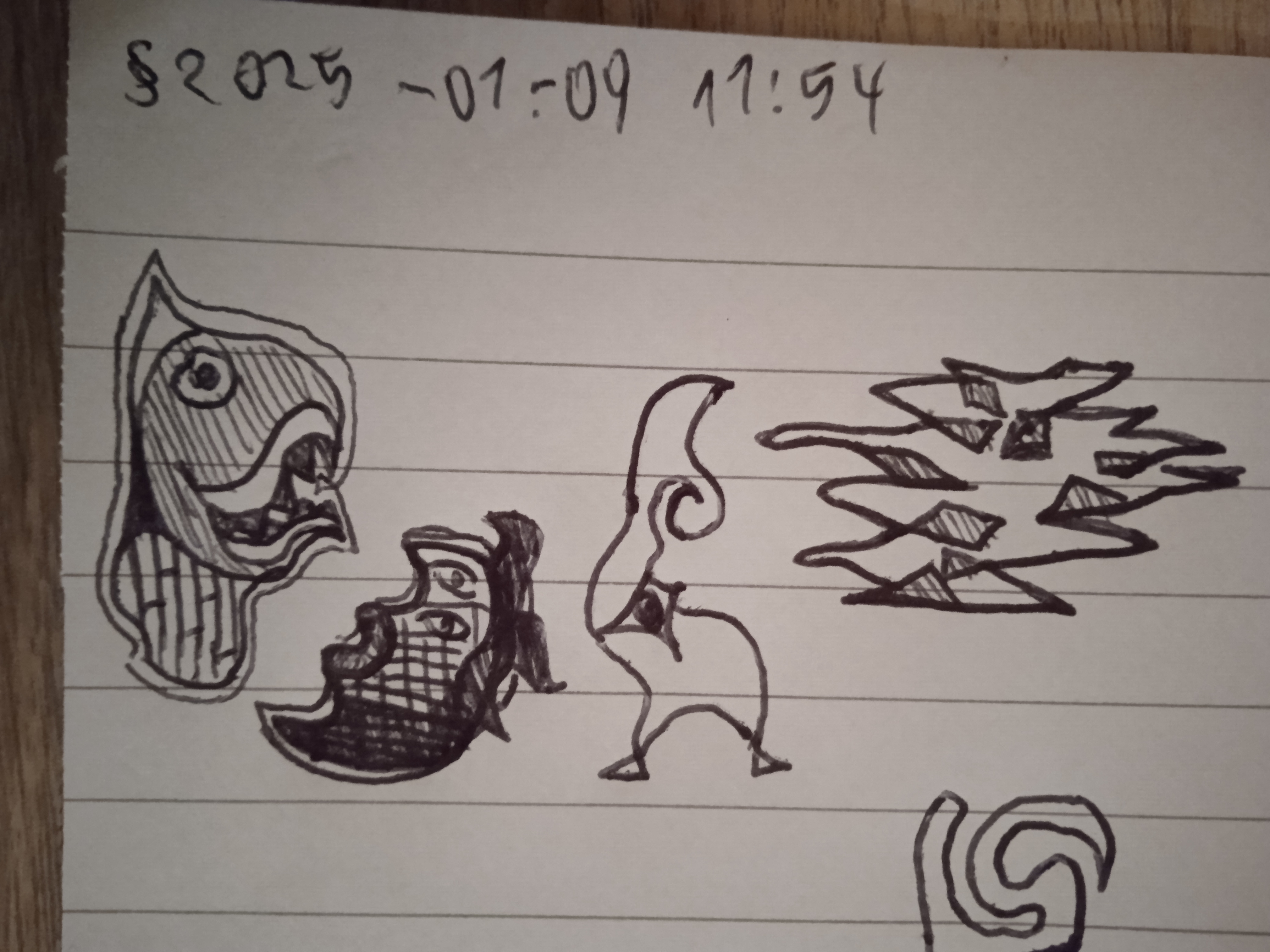 a piece of paper on which can be seen a black pen drawing depicting, from left to right, a somewhat Aztec-y beast, a moon-shaped creature with human lips and tentacle-like hair, a strange thing with to bottom limbs, a star-shaped eye and a curly horn, and a spiky and dotty structure